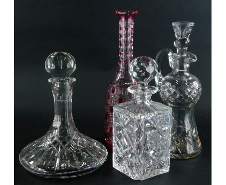 A late 20thC cut glass ships decanter, with orb stopper and a repeat hobnail cut decoration, 27cm high, two further decanters