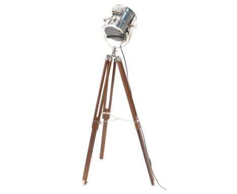 A hardwood and chrome floor lamp, modelled in the form of a cinema lamp.