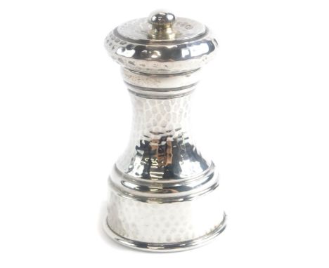 A George V silver pepper grinder, with hammered decoration, London 1911, 9cm high.