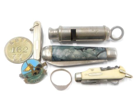 An Acme chrome plated whistle, of cylindrical form with hook top, 8cm high, three miniature pen knives, an enamel Mablethorpe