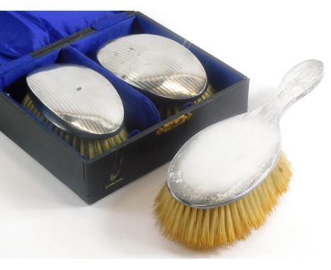 A pair of George V silver mounted clothes brushes, with engine turned decoration and vacant cartouche, Birmingham 1920, boxed