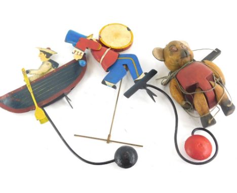 An Edwardian style child's iron weighted boy in boat toy, partially painted, 38cm high, another formed as a drummer, and a tr