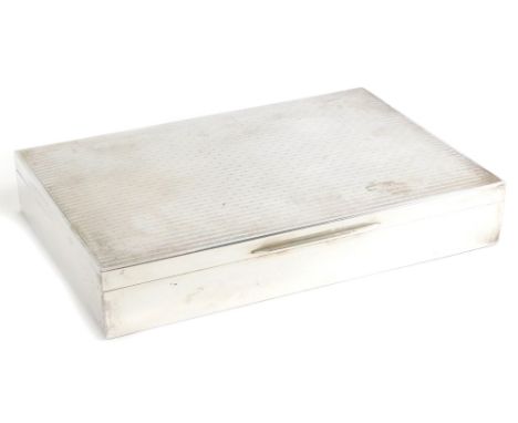 An early 20thC white metal cigarette box, of rectangular form with engine turned decoration, the hinged lid revealing a three