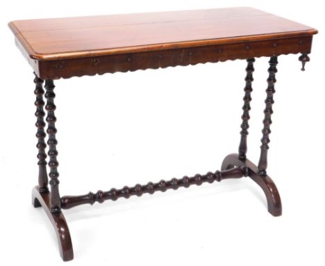 A Victorian mahogany library table, the rectangular top with a moulded edge and a crenellated frieze with drop finial, on twi