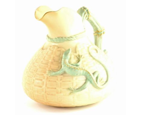 A Royal Worcester porcelain ewer, decorated with a lizard in green on a blush ivory ground, printed marks in puce to undersid