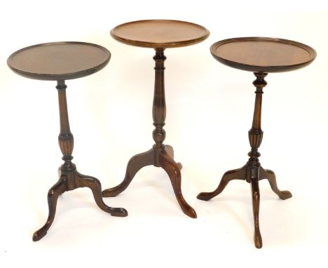 Three mahogany wine tables, each with a dished top, a turned column and a tripod base, 53cm, 57cm and 52.2cm high respectivel