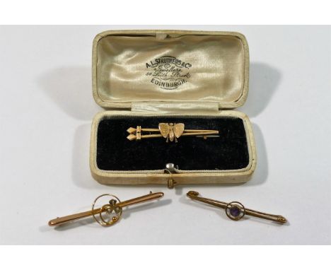 A Victorian yellow metal bar brooch in the form of two arrow heads and an insect, 4cm long, with steel pin, 3.8g gross and tw