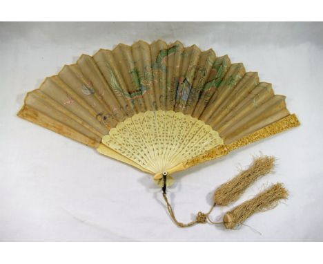 A late 19th century Chinese fan, with embroidered dragon decoration, the pierced and carved ivory sticks decorated with figur