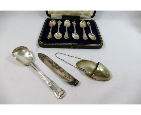 A set of six Art Nouveau style silver teaspoons, Sheffield 1922, cased, a Victorian silver cake knife blade and a large Victo