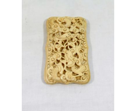 An early 20th century Chinese ivory calling card case, pierced and carved with dragons, 9.5cm x 5.75cmPlease note it is the b