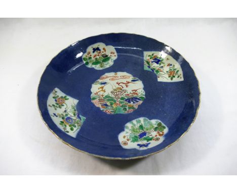 A Chinese famille vert blue ground dish, the centre panel decorated with shellfish, the outer panels decorated with insects a