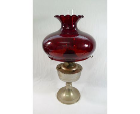 A 20th century 'Super Aladdin' oil lamp with a large ruby glass shade, 50cm high CONDITION REPORT: If you require further ima