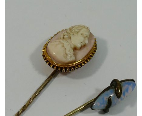 A Victorian gold mounted carved shell cameo topped stick pin and a simulated opal topped stick pin (2) CONDITION REPORT: If y