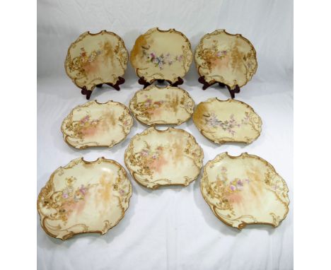 Nine late 19th century G D and Cie Limoges Rococo style porcelain dessert plates, retailed by R. Hogg and Co., Belfast, with 