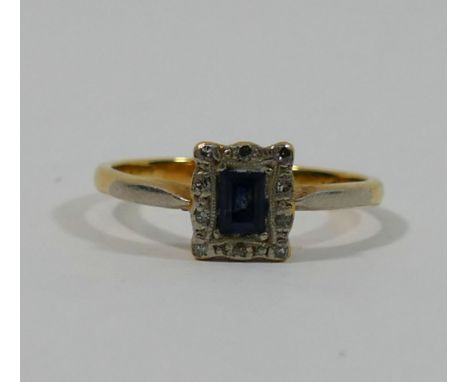 An Art Deco style small sapphire and diamond rectangular cluster ring, the baguette cut sapphire set within small eight-cut d