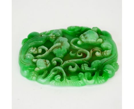 A Chinese carved jade amulet of two young dragons with lotus, 11 x 9 x 1cm.