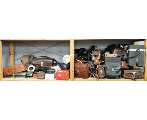 A group of mixed photographic equipment and camera cases.