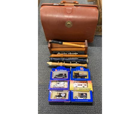A vintage leather briefcase containing Diecast models, recorders and other items.
