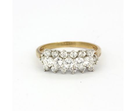 A hallmarked 9ct yellow gold ring set with round cut cubic zirconias, (T.5).