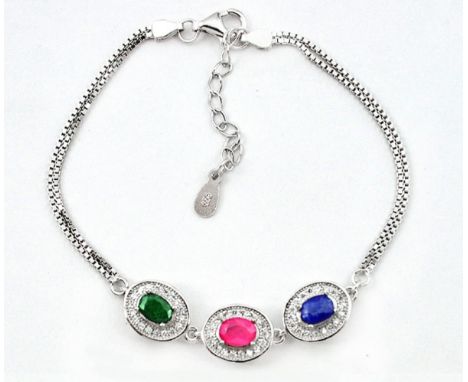 A 925 silver bracelet set with oval cut ruby, sapphire and emerald surrounded by white stones, L. 18cm.