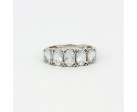 A 9ct white gold ring set with oval cut aquamarines and diamonds, (M).