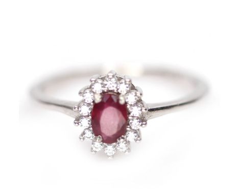A 925 silver cluster ring set with an oval cut ruby and white stones, (Q).