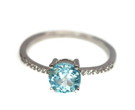 A 925 silver ring set with round cut blue topaz and white stones, (R.5).