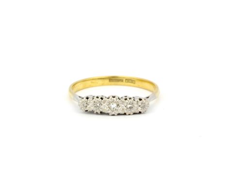 An 18ct yellow and white gold diamond set ring, (S.5).