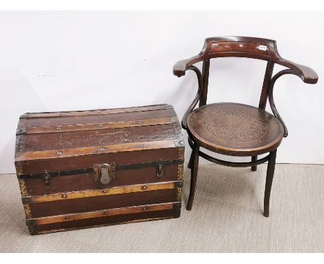A bentwood armchair and a dome topped trunk.