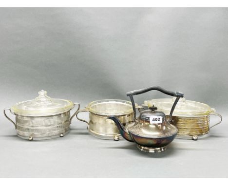 Three vintage silver plate oven proof glass serving dishes and a silver plated kettle.