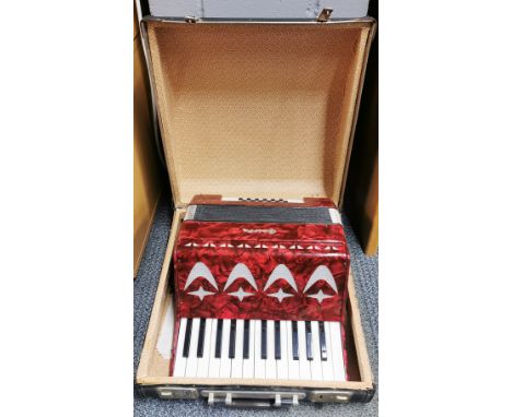 A vintage cased piano accordian.