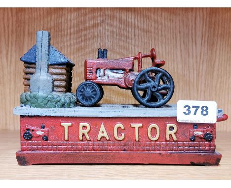 A cast iron reproduction tractor money box, L. 22cm.
