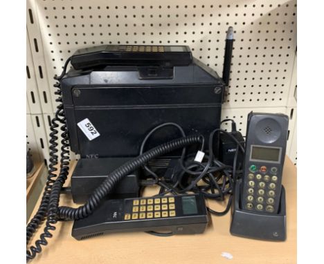 A vintage NEC mobile telephone and rechargable handset.