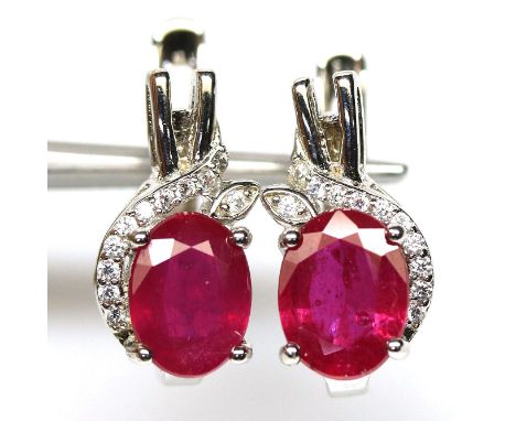 A pair of 925 silver earrings set with oval cut ruby and white stones, L. 1.5cm.