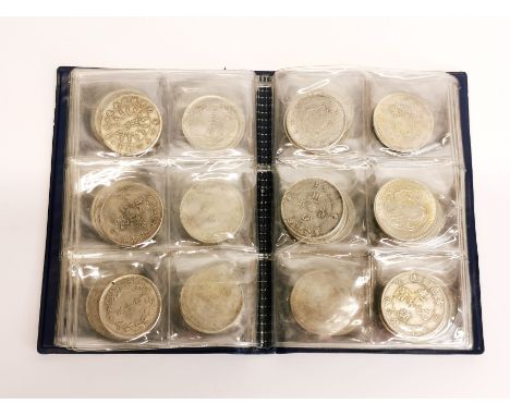 A folder of mixed Chinese coins and medals.&nbsp;(These coins do not appear to be silver)