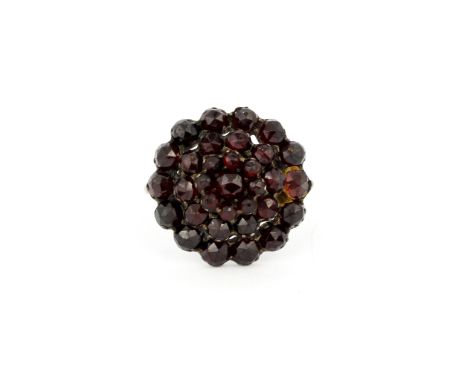 A yellow metal large cluster ring set with rose cut garnets, (S.5).