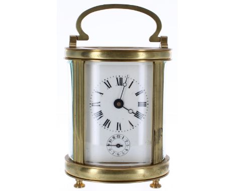 French carriage clock timepiece with alarm sounding on a bell beneath the base, within an oval brass case, 6.5" high (key) 