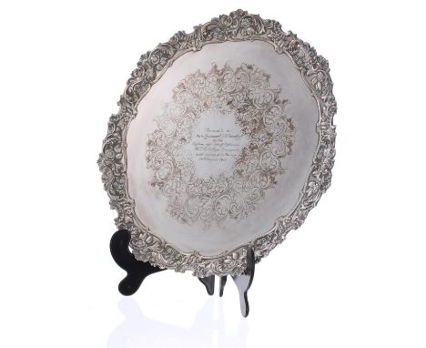 Large cast silver plated circular tray, with scrolling foliate moulded rim and presentation inscription to the centre, marked