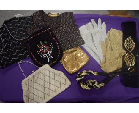 A selection of vintage evening bags, two 1960s tank tops, two pairs of gloves and two belts.