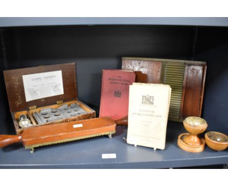 A selection of vintage pharmaceutical items, including pill roller and closing machine, books, and treen pill silverer.