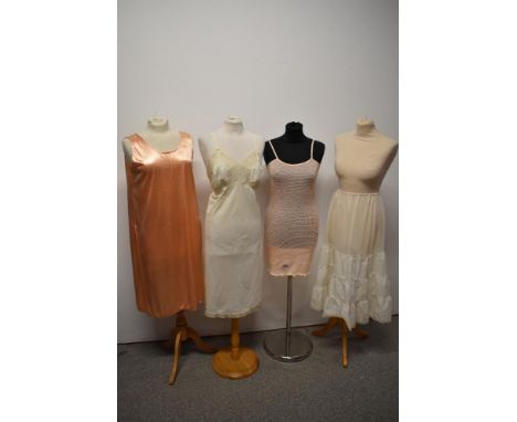A selection of vintage lingerie, to include CC41 utility labelled knitted slip, 1930s peach slip and two petticoats.