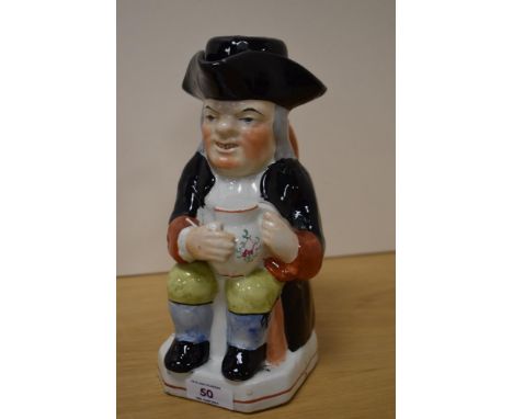A Victorian Staffordshire Toby jug or pitcher, with stopper, measuring 24cm tall