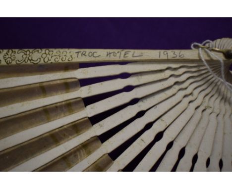 A vintage fan, having bone ribs, sold with another paper fan with hand painted decoration.