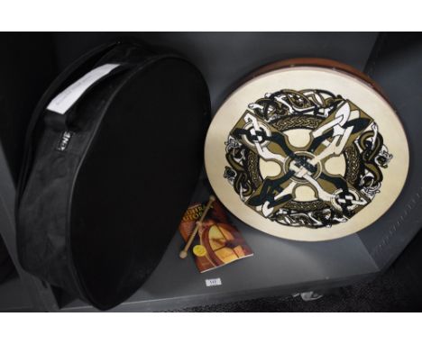 A Bodhran Irish drum with case and tuition book.