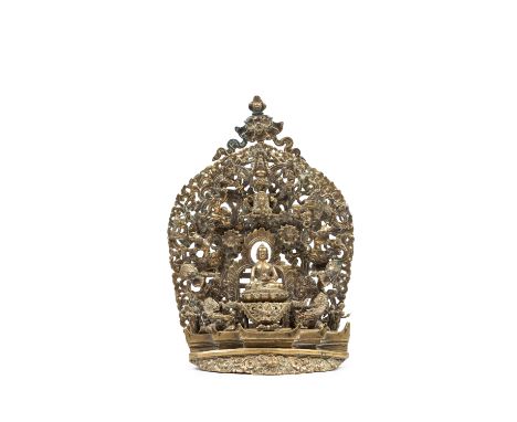 h cm 27,5The sculpture depicts a scene from the life of the Buddha. At the base of the group, a finely repoussé Garuda head s