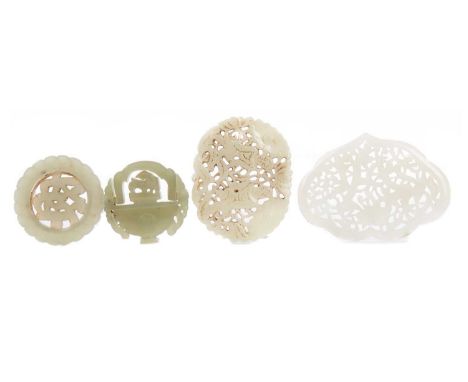 TWO CHINESE JADE AMULETS,one with pieced designs of figures amongst foliage, 7cm wide, along with two further jade carvings w