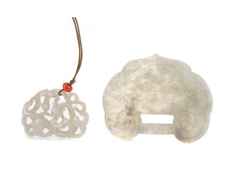 TWO CHINESE MUTTON JADE CARVINGS,the larger modelled as a ruyi head with floral spray to one side and four character oracle b