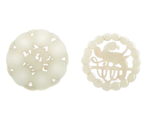 TWO CHINESE CARVED MUTTON JADE ROUNDELS,the larger featuring a bat and peaches, 5.8cm diameter, the smaller with central para