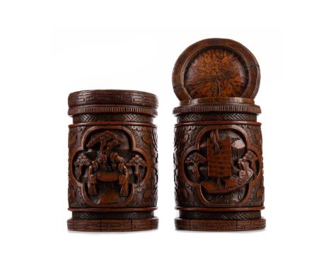 PAIR OF CHINESE BAMBOO BRUSH POTS/ TOBACCO JARS,carved in high relief with scenes of figures in natural landscapes against fl