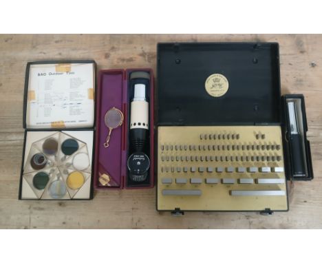 A mixed lot comprising a Pitter Gauge Tool Co weight set, two optometrists tools and a BAO Outdoor Tint set.